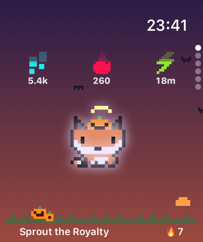 A fox in a pumpkin hat under a Halloween evening sky